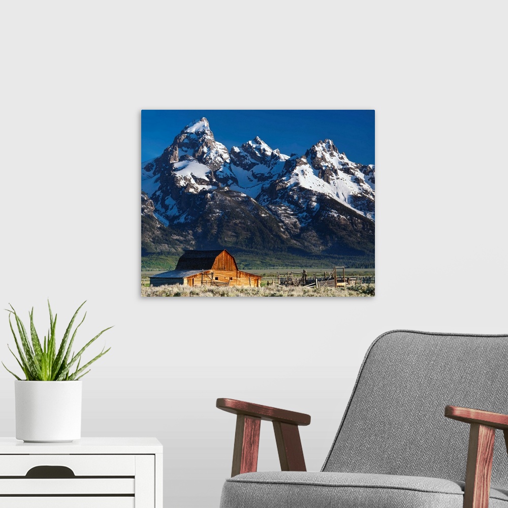 A modern room featuring A photograph of a the Grand Teton national park.