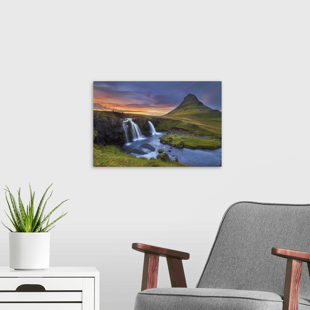 A modern room featuring A photograph of an Icelandic landscape with waterfalls to the left and a sunset cloudscape hangin...