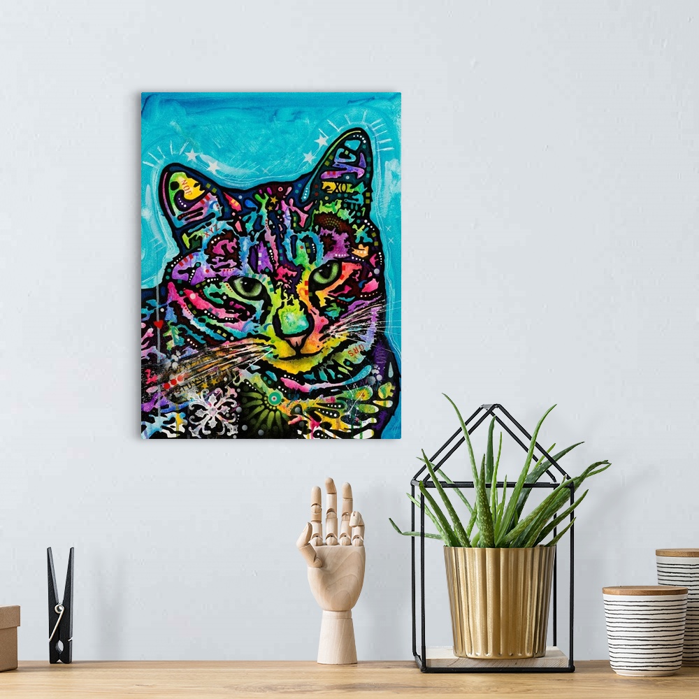 A bohemian room featuring Colorful painting of a cat named Kismet covered in abstract markings on a blue background.
