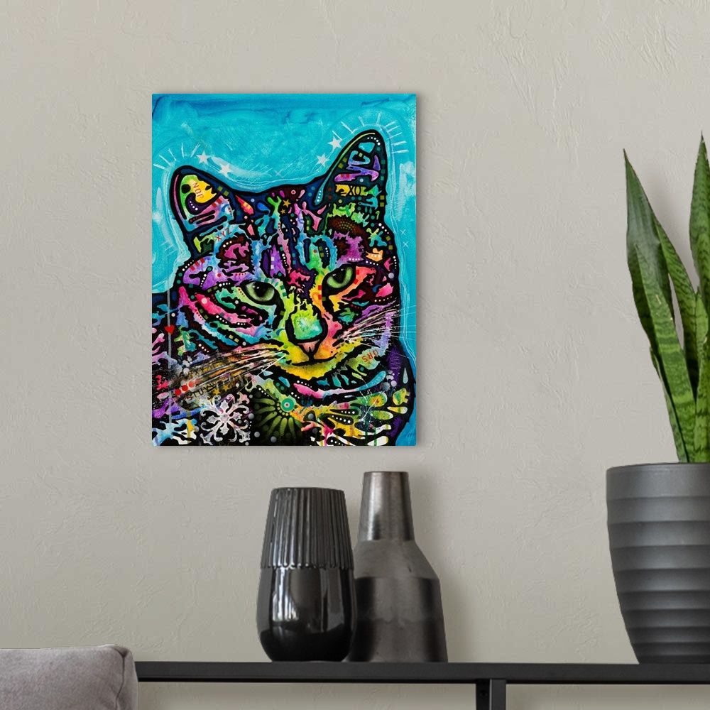 A modern room featuring Colorful painting of a cat named Kismet covered in abstract markings on a blue background.