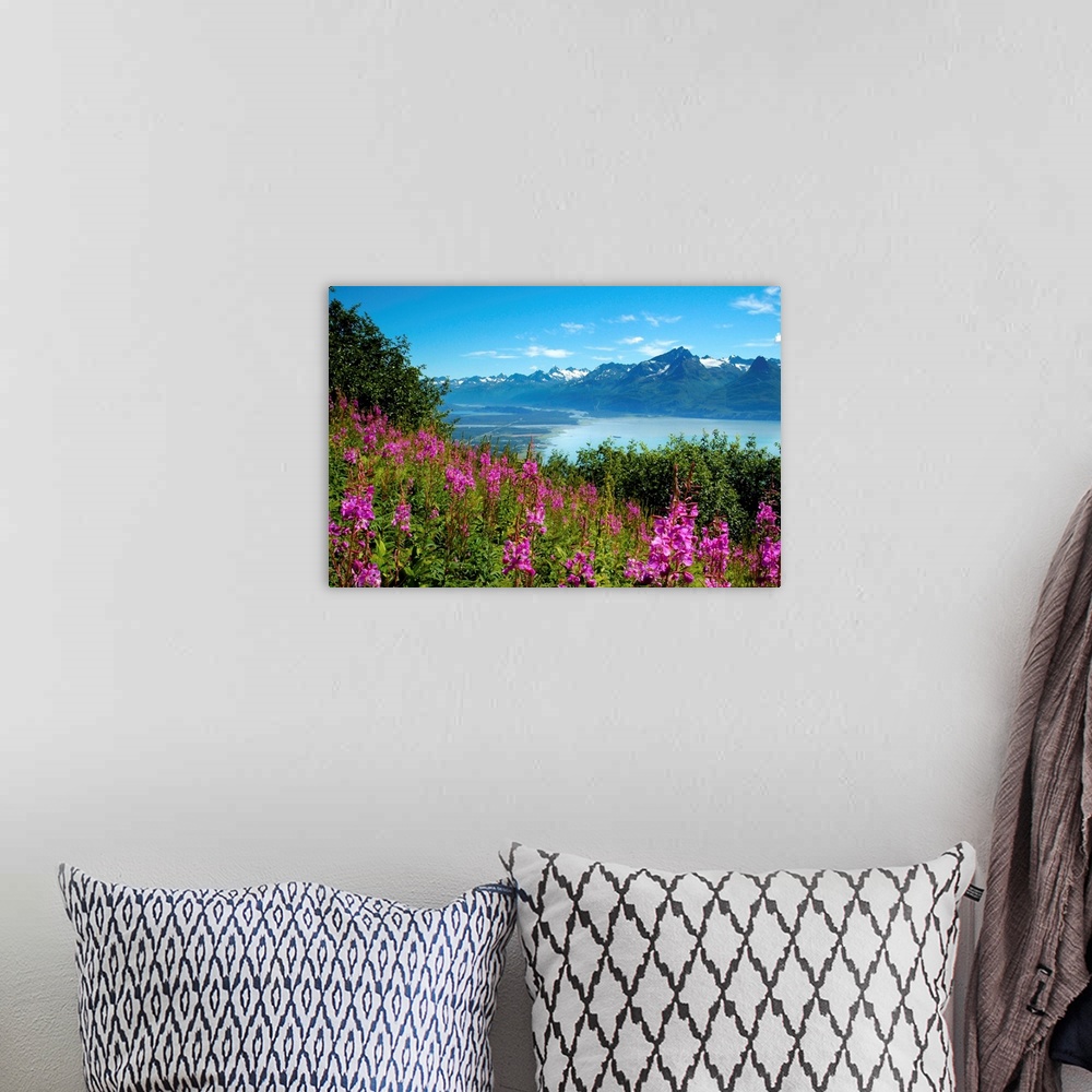 A bohemian room featuring Landscape photograph from a field of pink flowers with a lake and mountains in the background.