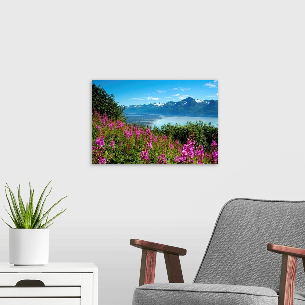A modern room featuring Landscape photograph from a field of pink flowers with a lake and mountains in the background.