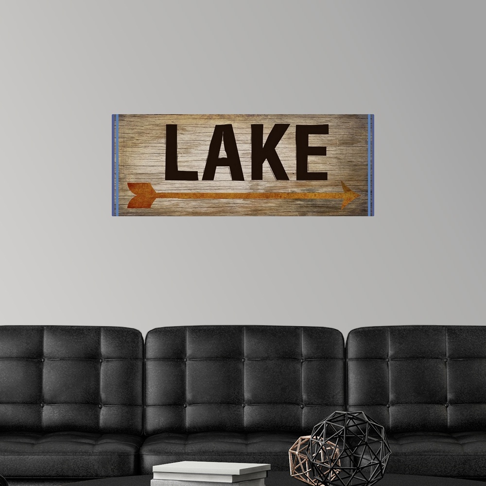 A modern room featuring Wooden sign with an orange arrow, 2 blue lines on each side, and the word "Lake" written across it.