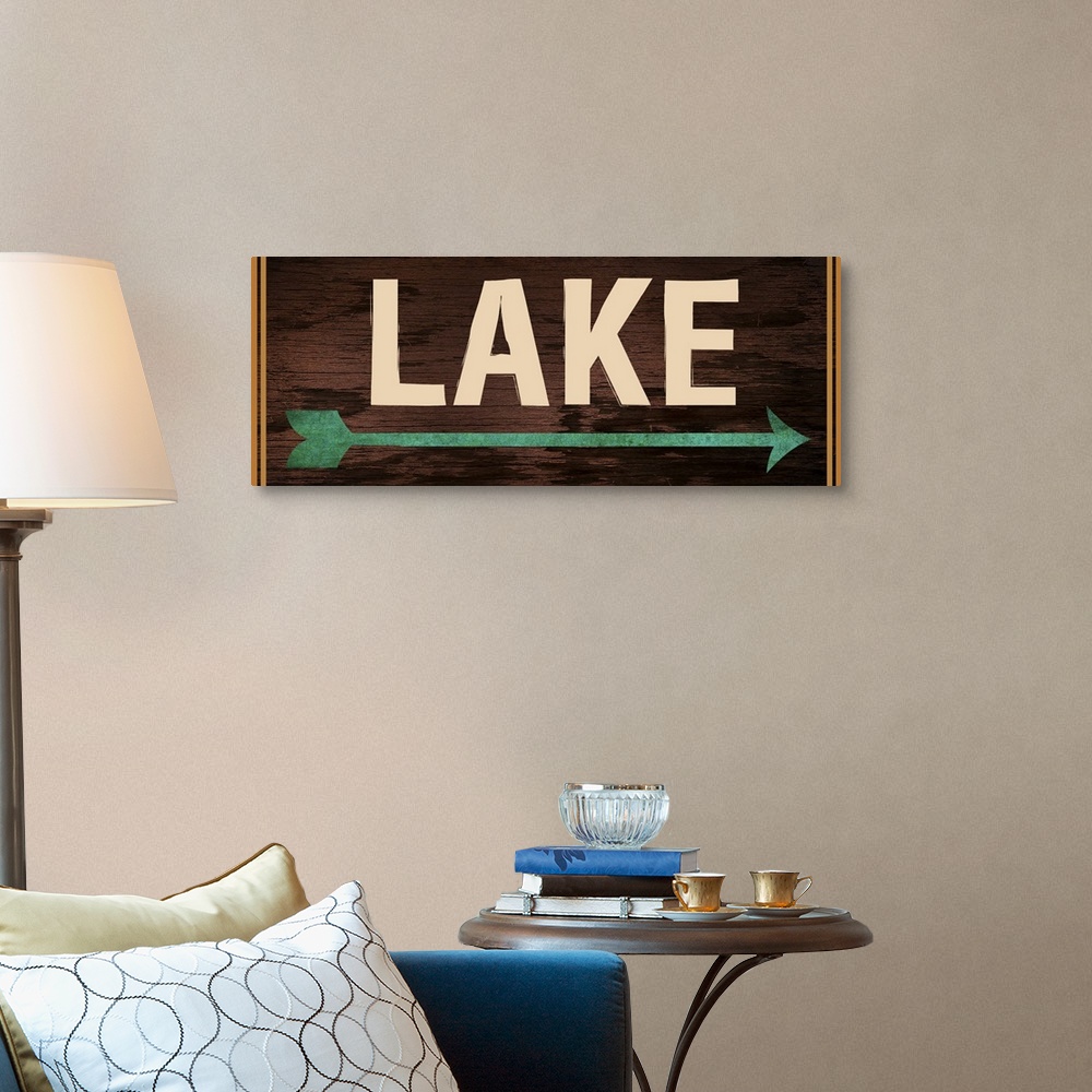 A traditional room featuring Dark wooden sign with a teal arrow, 2 orange lines on each side, and the word "Lake" written acro...
