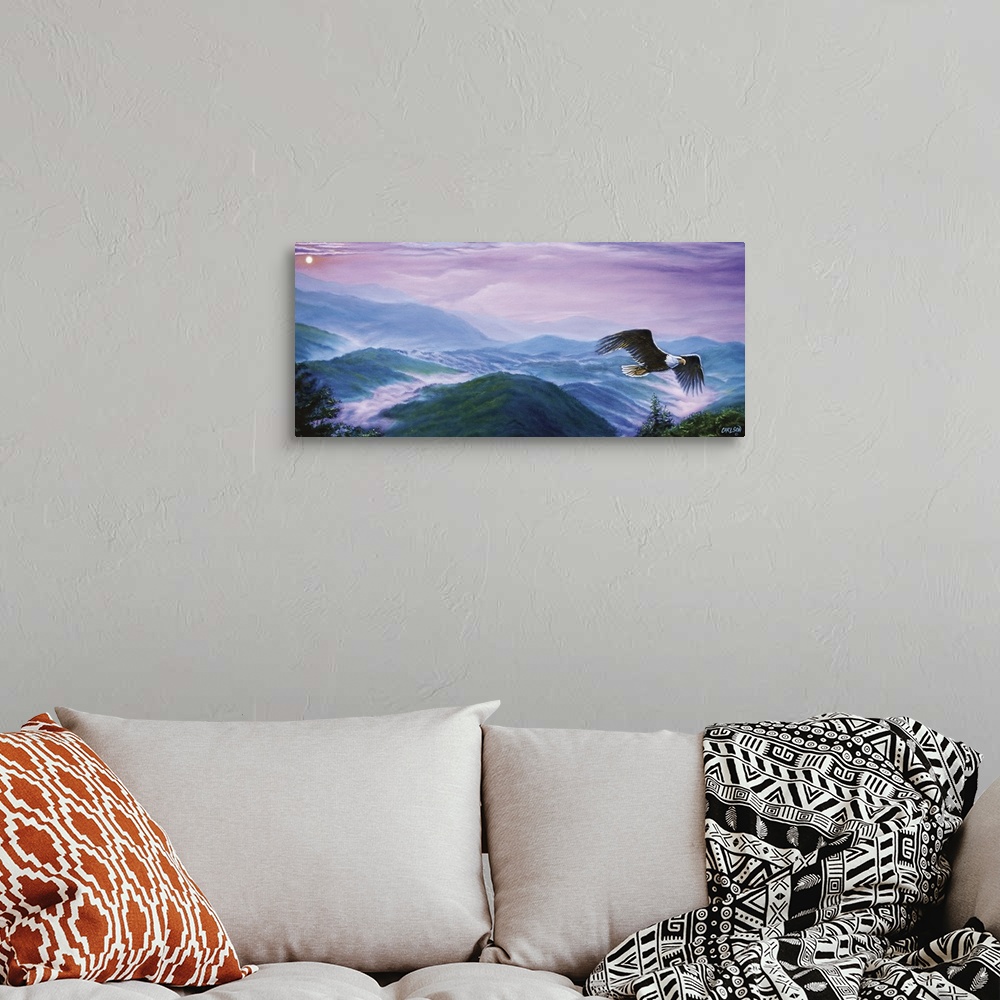 A bohemian room featuring bald eagle flying over mountain range