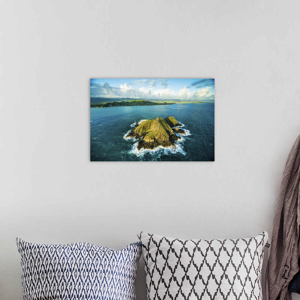 A bohemian room featuring An aerial photograph looking over the Hawaiian islands.
