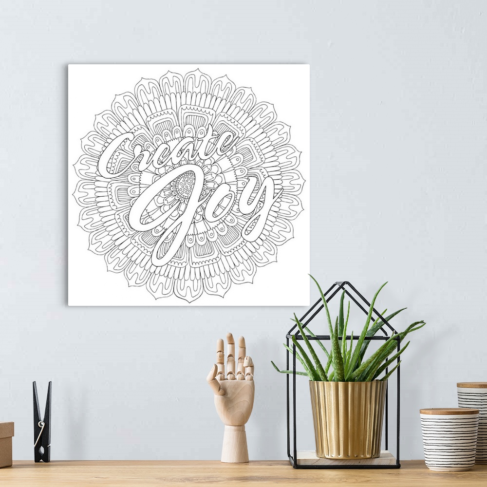 A bohemian room featuring Black and white line art with the phrase "Create Joy" written on top of a round floral design