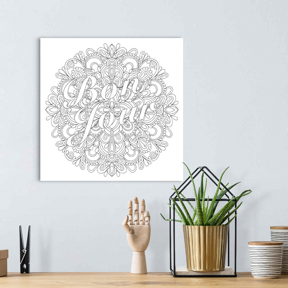 A bohemian room featuring Black and white line art with the phrase "Bon Jour" written over a round floral design.