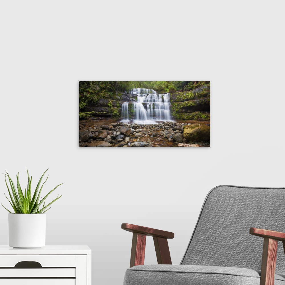 A modern room featuring A photograph of a multi-leveled waterfalls