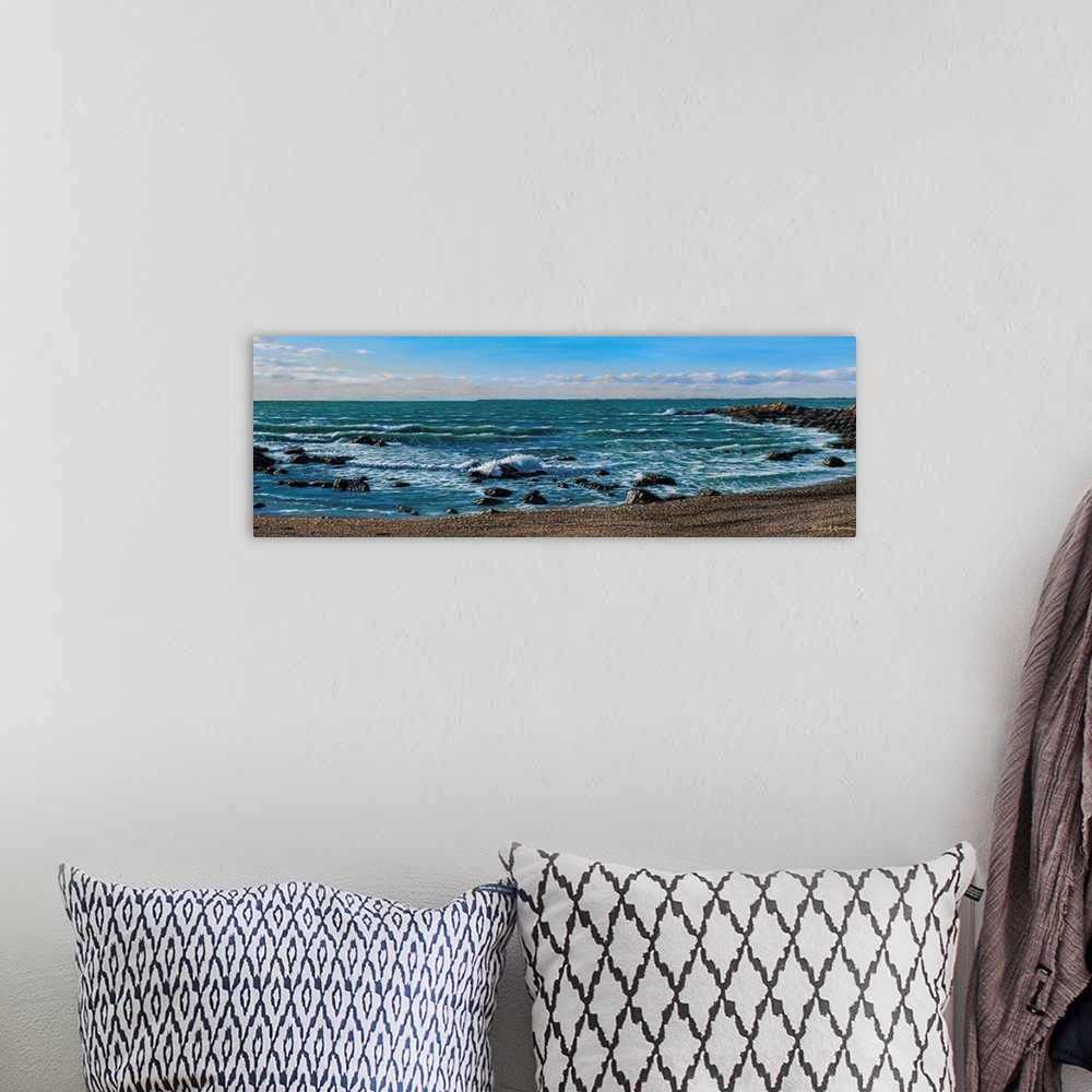 A bohemian room featuring Contemporary painting of waves splashing on a sandy beach.