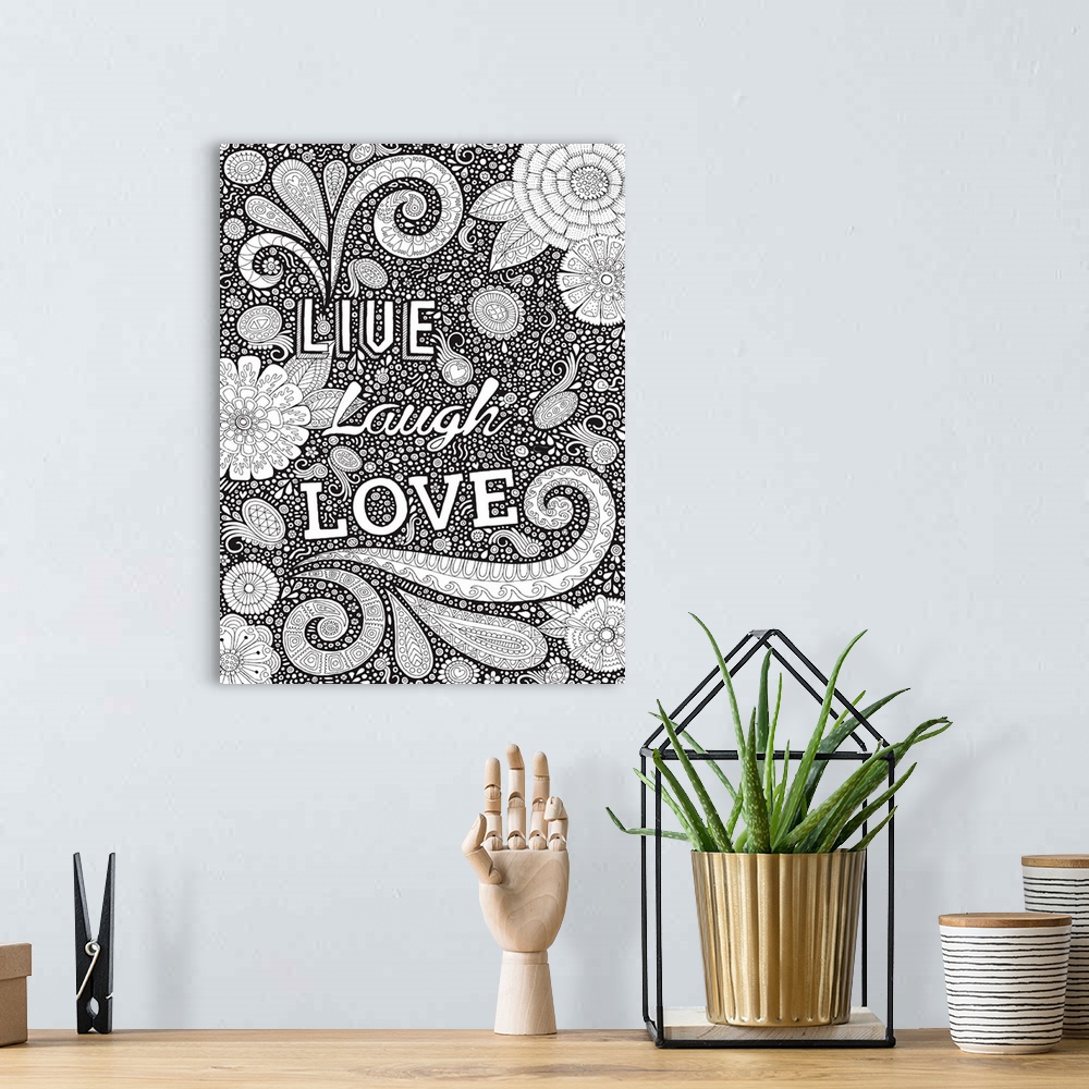 A bohemian room featuring Black and white line art with the phrase "Live Laugh Love" written on top of an intricately desig...