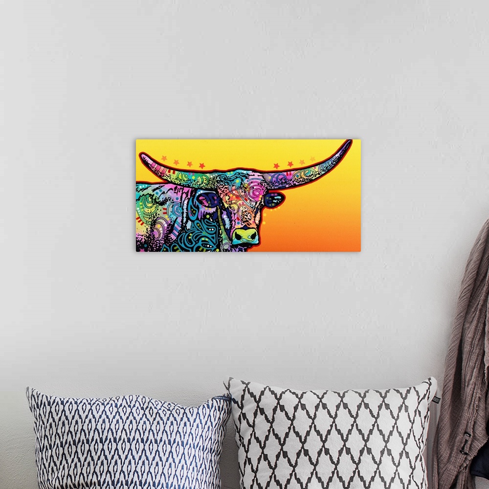 A bohemian room featuring Colorful painting of a longhorn with abstract designs on a yellow and orange gradient background.