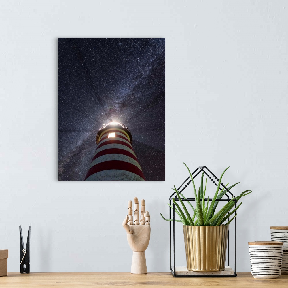 A bohemian room featuring Photograph looking up at a red and white striped lighthouse to a purple and blue starry sky with ...