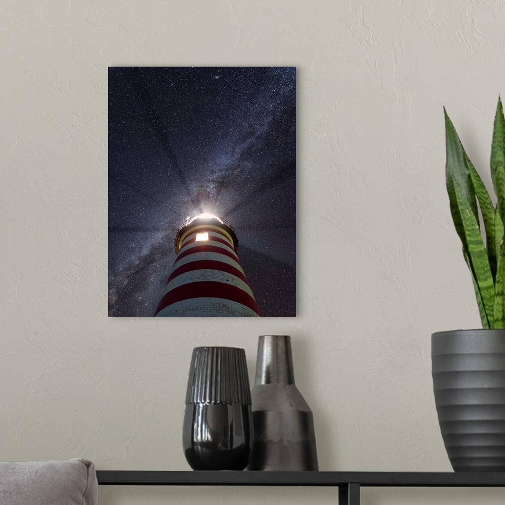 A modern room featuring Photograph looking up at a red and white striped lighthouse to a purple and blue starry sky with ...