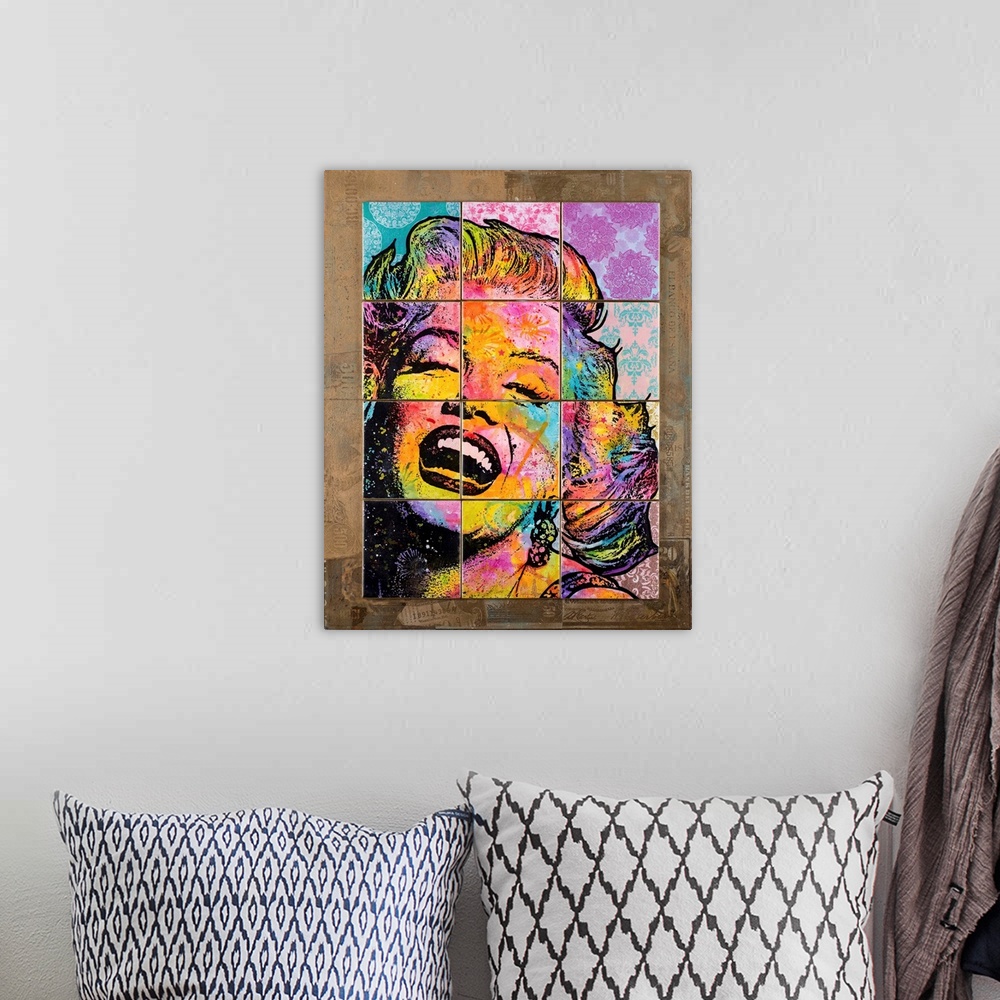 A bohemian room featuring 12 colorful tiles placed together to create Marilyn Monroe's face on top of a brown background wi...