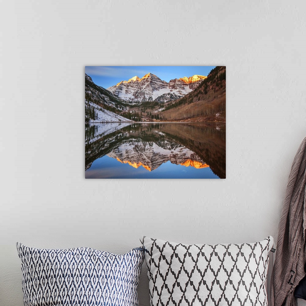 A bohemian room featuring Sunlight on the peaks of the Maroon Bells, reflected in the lake below.
