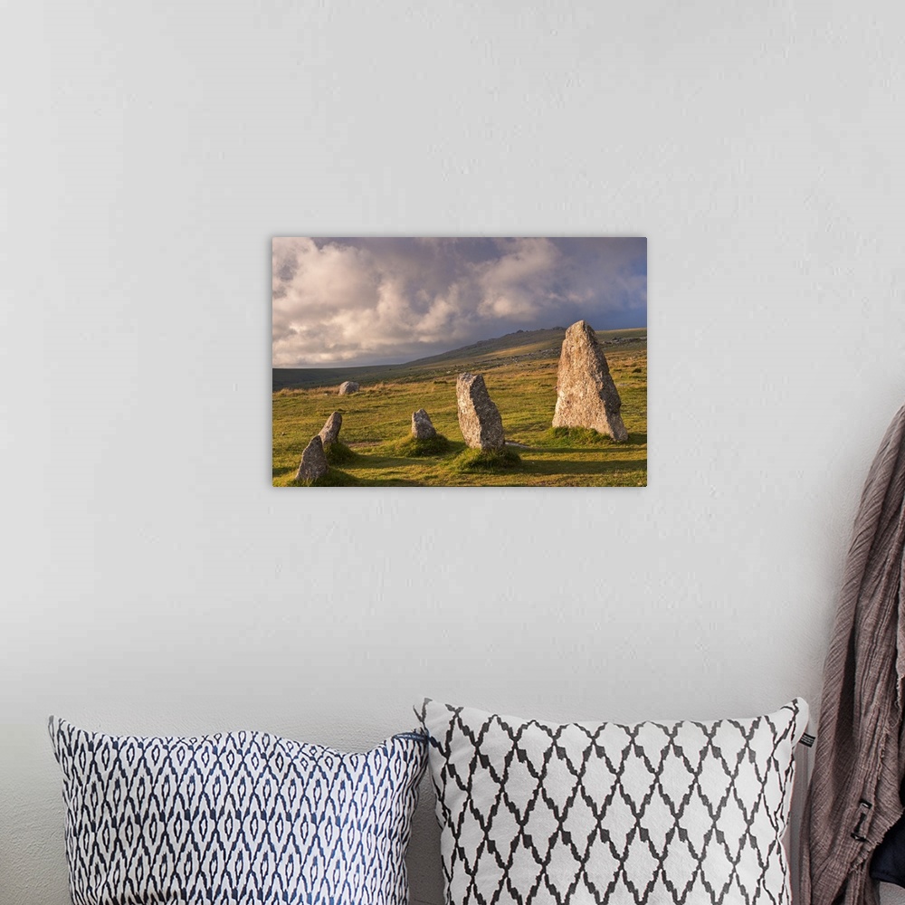A bohemian room featuring Standing stones in a grassy meadow with cloudy skies.