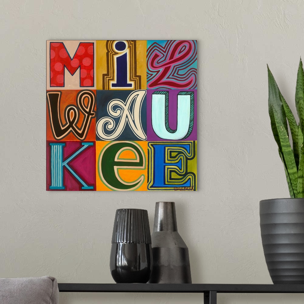 A modern room featuring Contemporary typography painting with the word Milwaukee spelled in different fonts.
