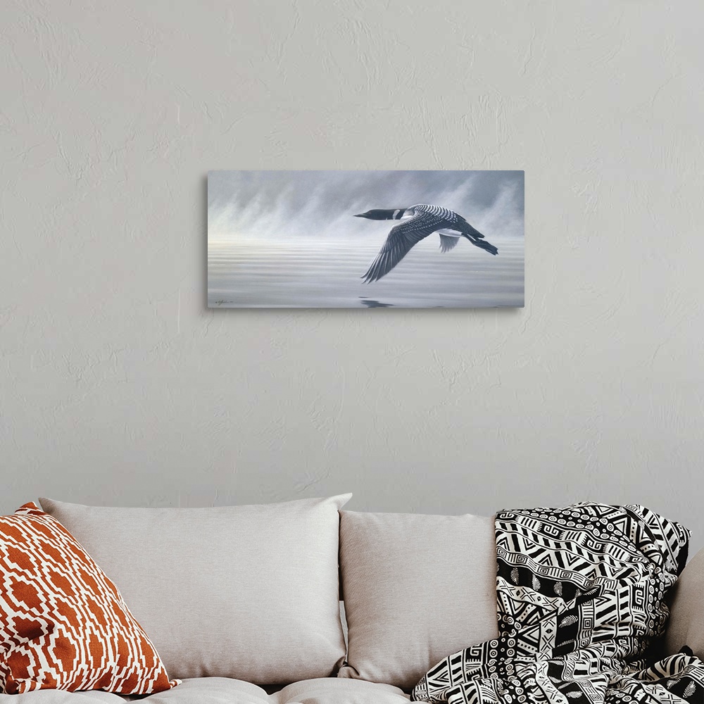 A bohemian room featuring Loon flying over misty water.