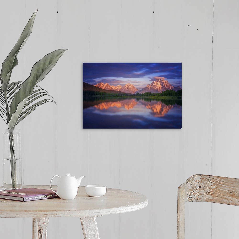 A farmhouse room featuring Clouds over Mt. Moran at sunset, reflected in the lake below.