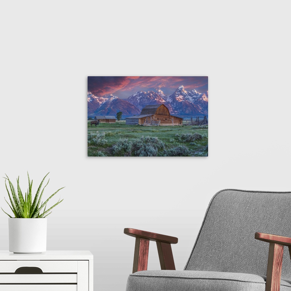 A modern room featuring A photograph of the Mormon Row Barn in Wyoming, with the Teton mountains in the background.