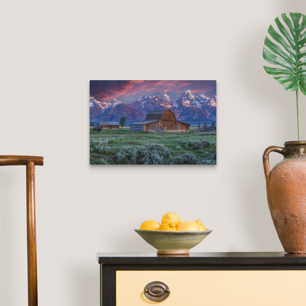 A traditional room featuring A photograph of the Mormon Row Barn in Wyoming, with the Teton mountains in the background.