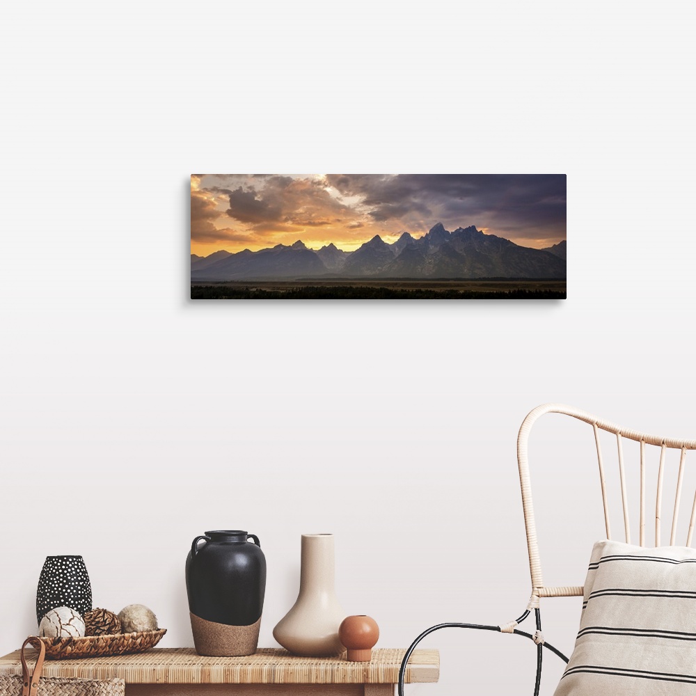 A farmhouse room featuring A photograph of mountains cast in shadow from the light of the setting sun.