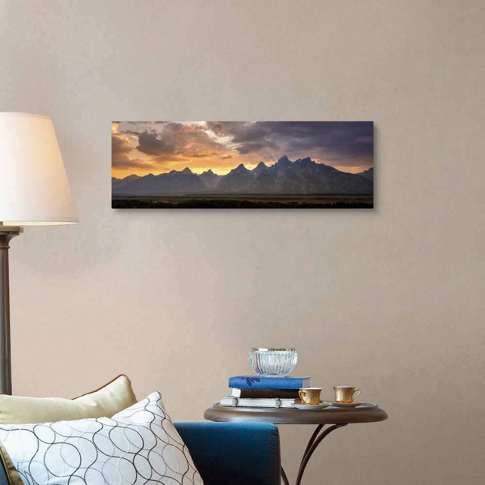 A traditional room featuring A photograph of mountains cast in shadow from the light of the setting sun.
