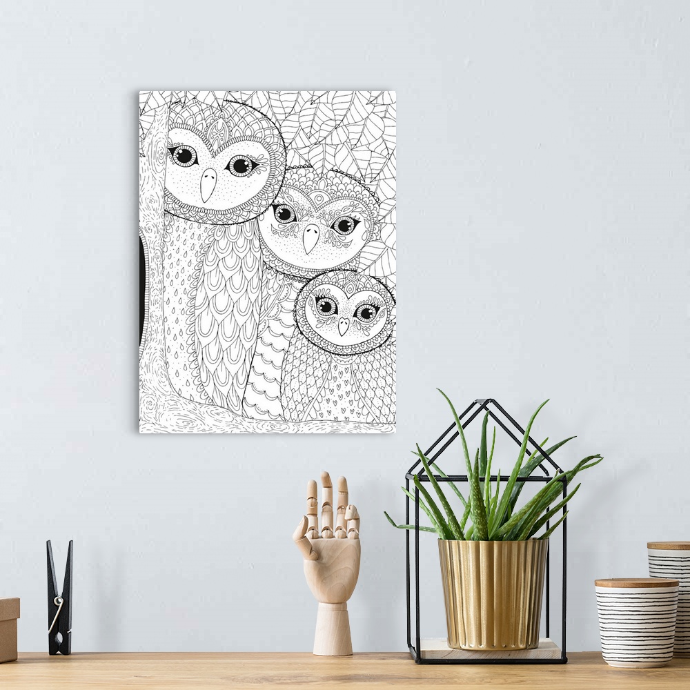 A bohemian room featuring Black and white line art of a family of owls in a tree with a leafy background.
