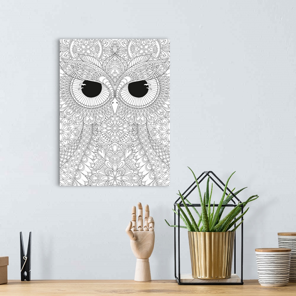 A bohemian room featuring Black and white line art of a close-up owl's face with big, black, fierce eyes.