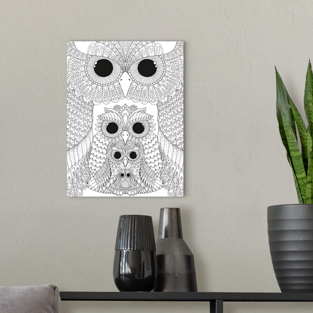 A modern room featuring Black and white line art of four intricately designed different sized owls stacked together.