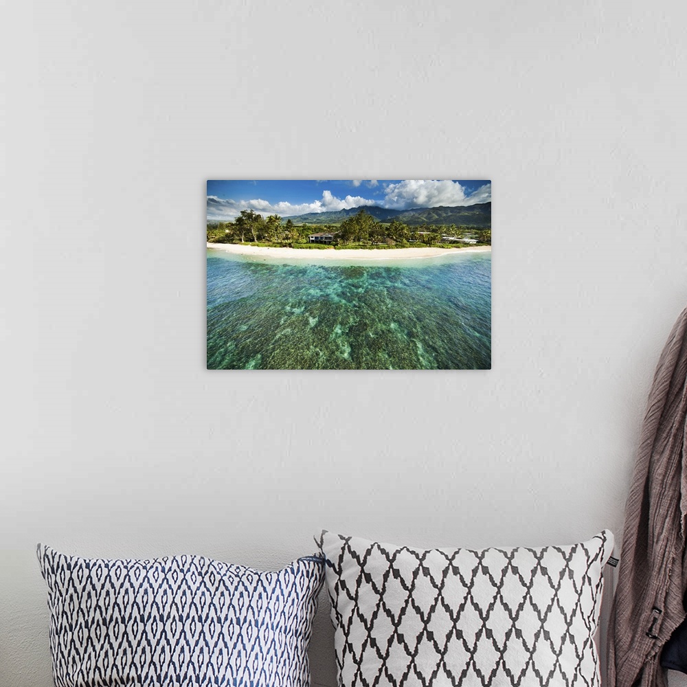 A bohemian room featuring An aerial photograph looking over the Hawaiian islands.