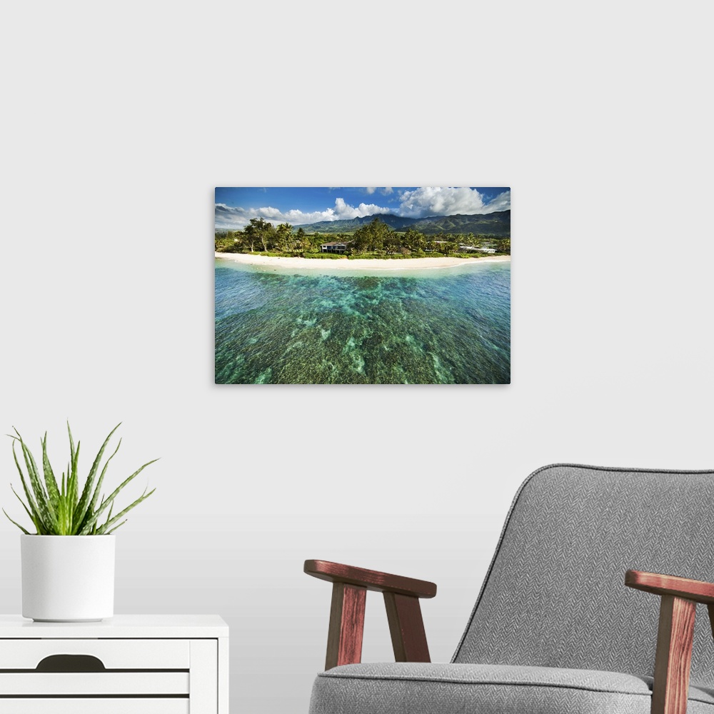 A modern room featuring An aerial photograph looking over the Hawaiian islands.