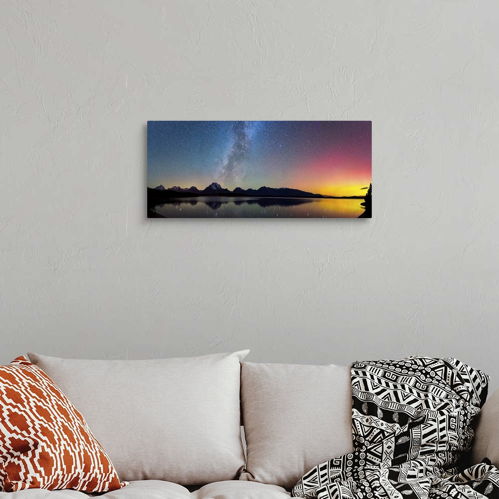 A bohemian room featuring Aurora Borealis and the Milky Way visible in the sky over a lake.