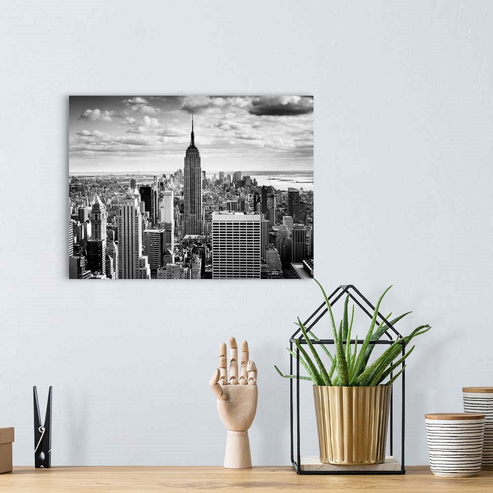 A bohemian room featuring Black and white photography of NYC downtown, with the New York empire state building prominently ...
