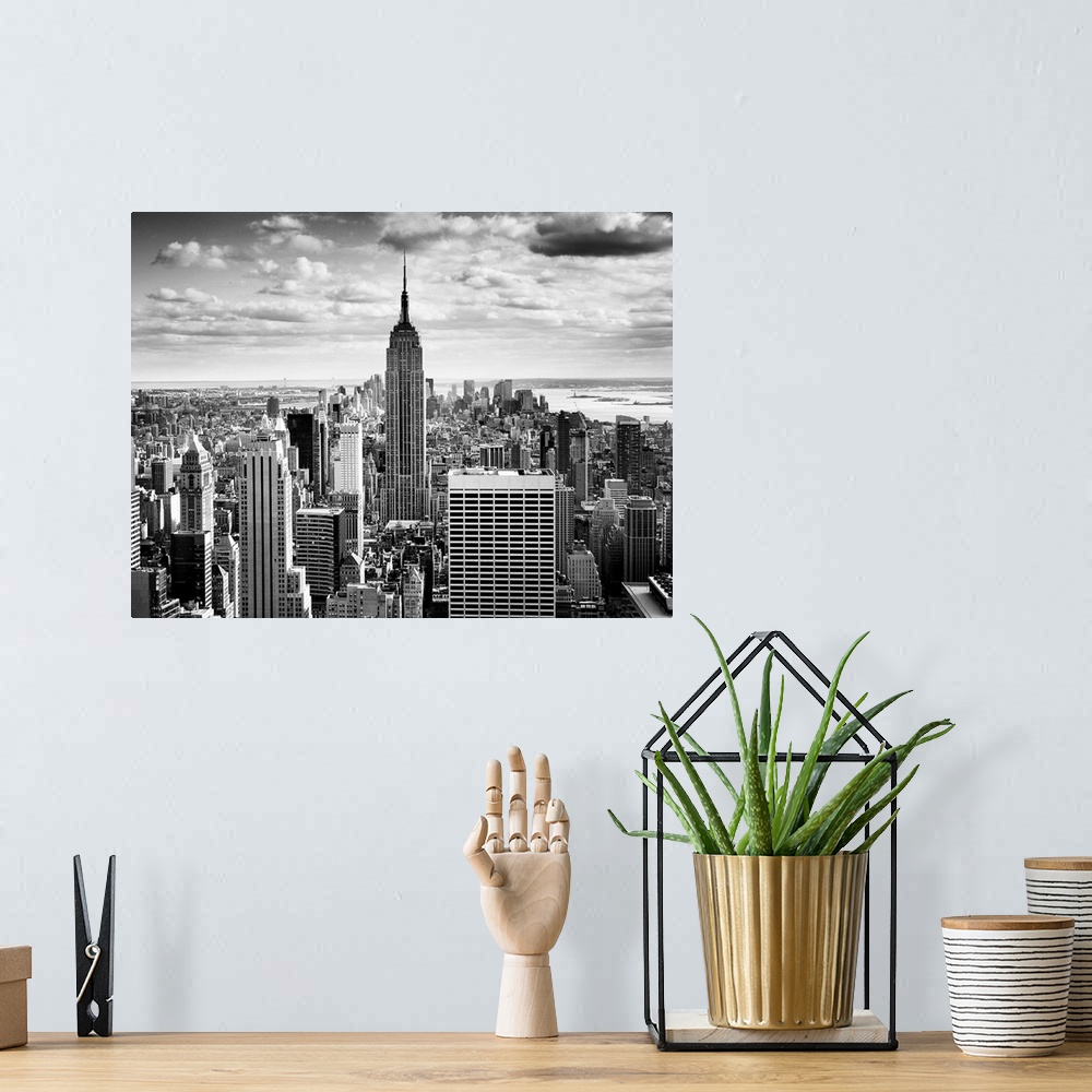 A bohemian room featuring Black and white photography of NYC downtown, with the New York empire state building prominently ...