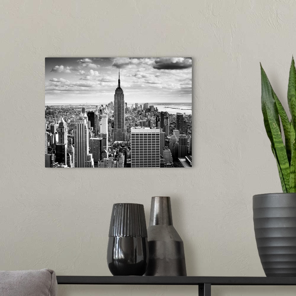A modern room featuring Black and white photography of NYC downtown, with the New York empire state building prominently ...