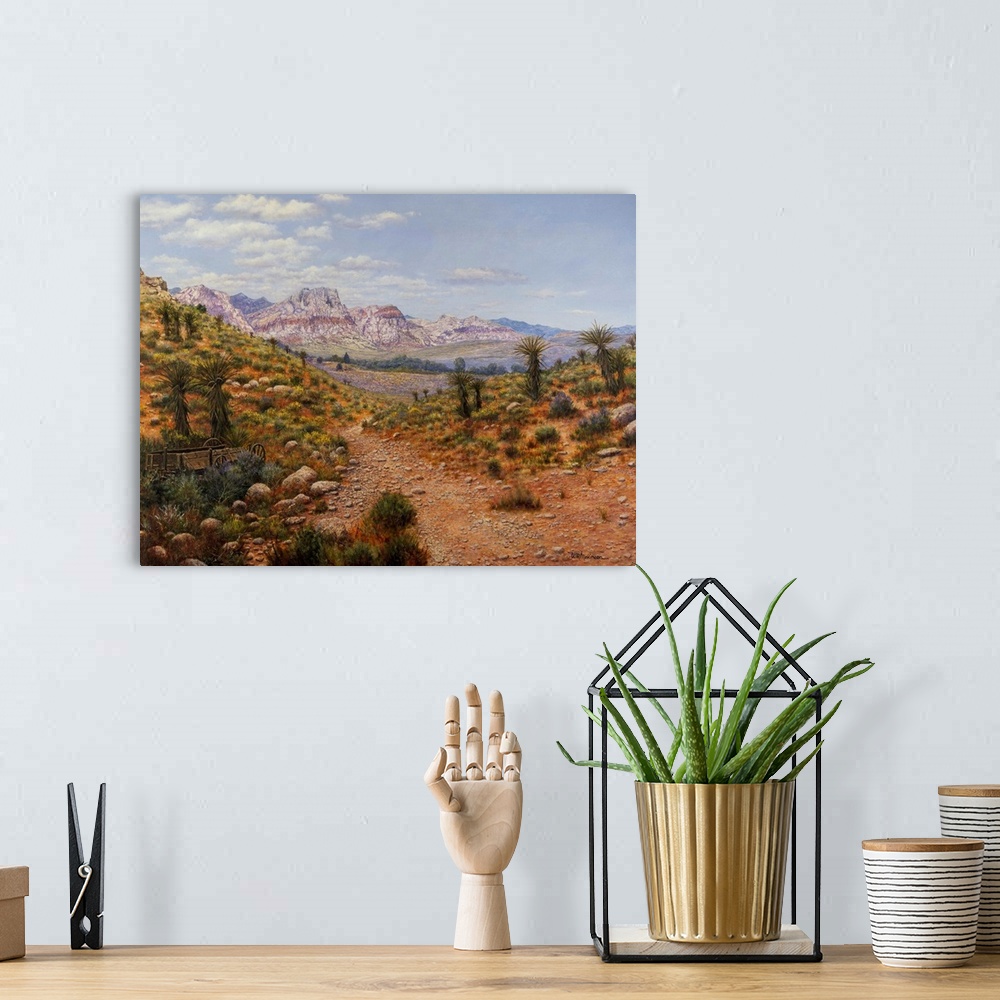A bohemian room featuring Dirt trail through arid land with canyons and water in distance.