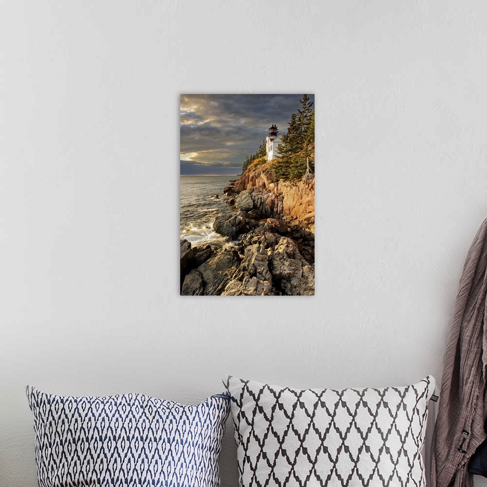 A bohemian room featuring A photograph of a lighthouse on a rocky escarpment on the coastline.