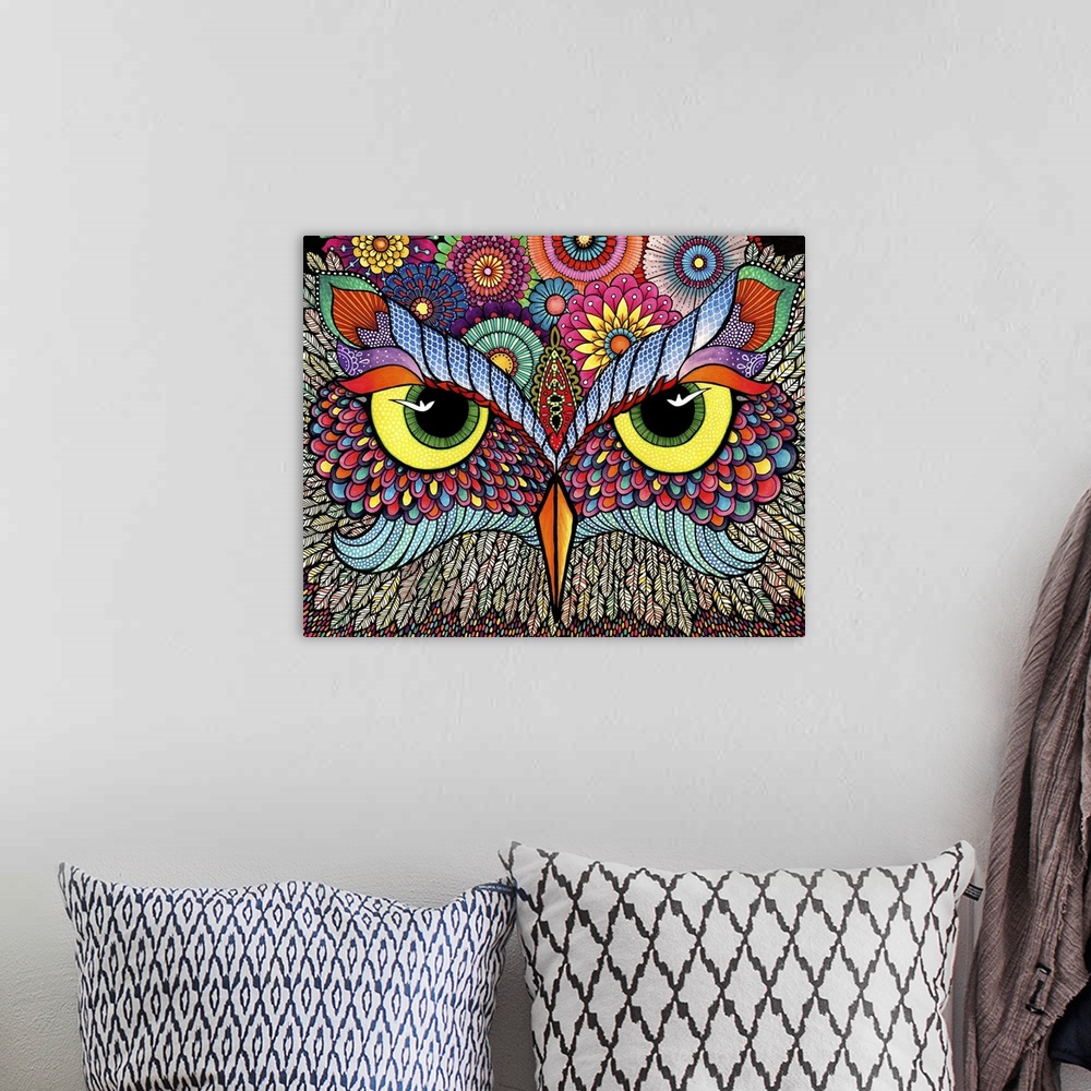 A bohemian room featuring Contemporary abstract artwork of a brightly colored and patterned owl face close-up.