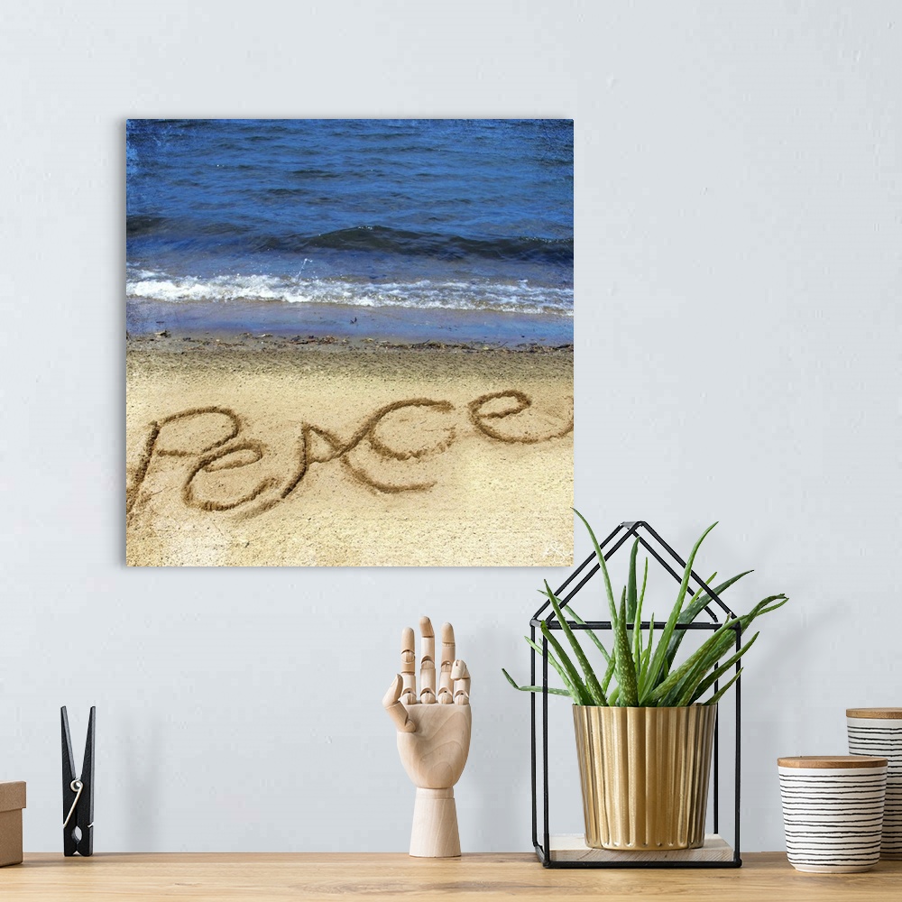A bohemian room featuring Photograph of a motivational sentiment written in the sand on a beach.