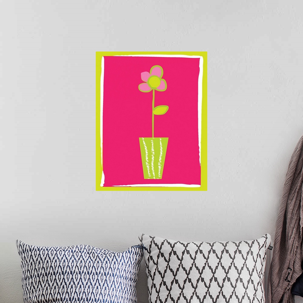 A bohemian room featuring pink flower in a vase