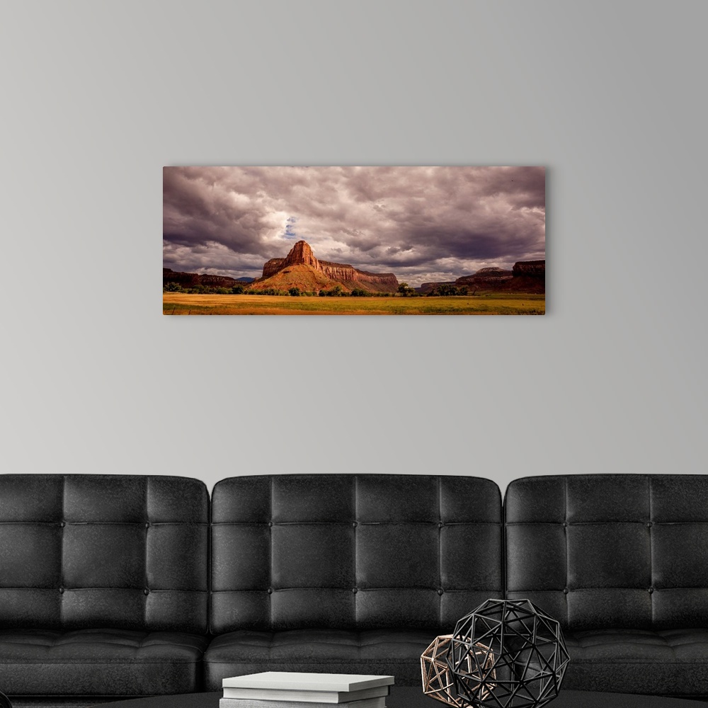 A modern room featuring Landscape photograph of large rock formations under a cloudy sky.