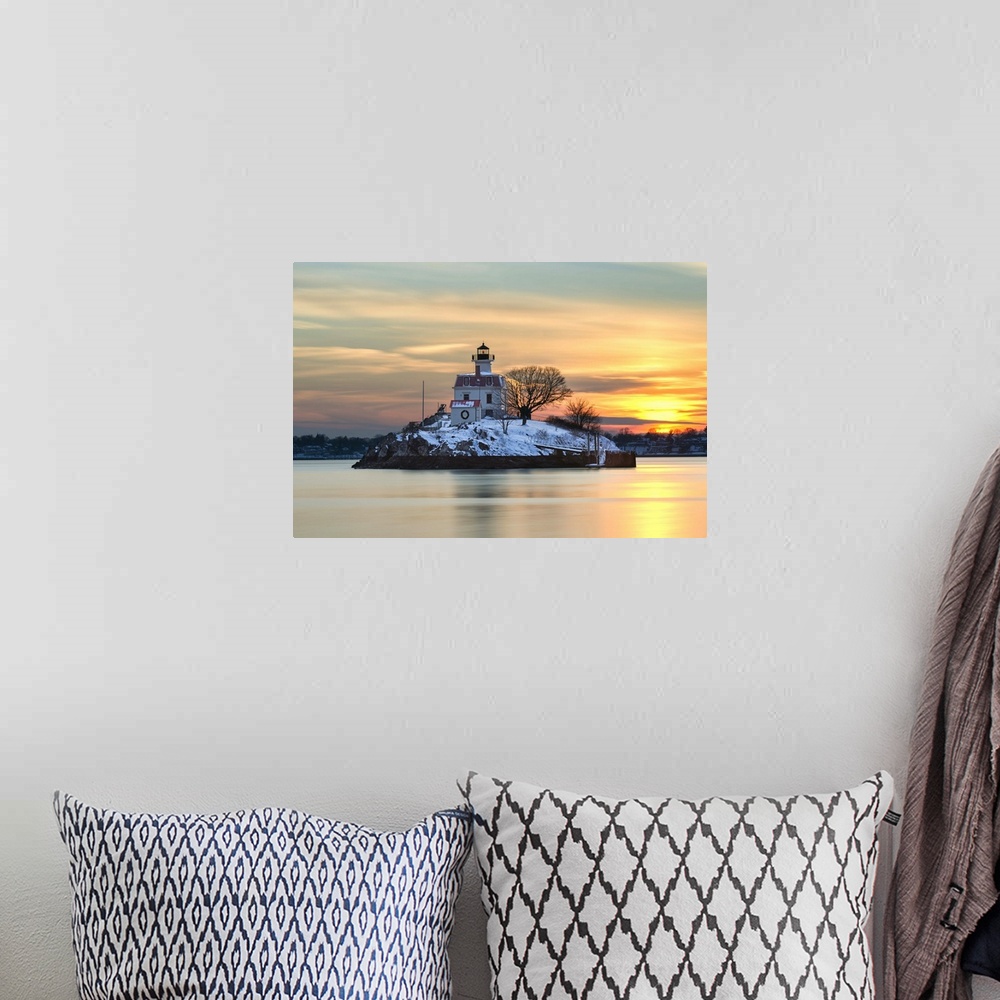 A bohemian room featuring A photograph of a lighthouse under a sunset sky.
