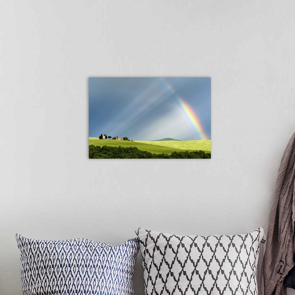 A bohemian room featuring A photograph of a Tuscan countryside bathed in the light streaming from a rainbow.