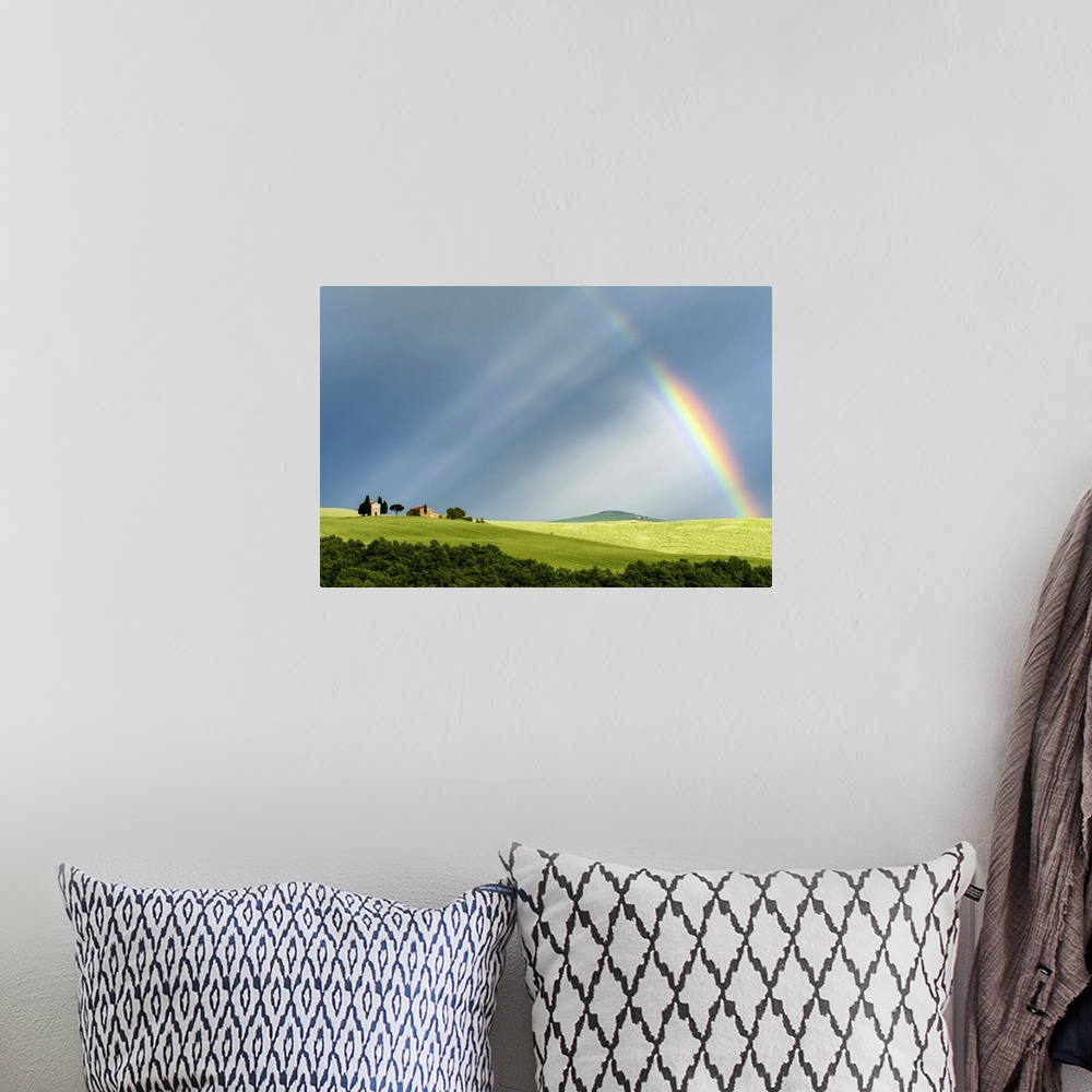 A bohemian room featuring A photograph of a Tuscan countryside bathed in the light streaming from a rainbow.