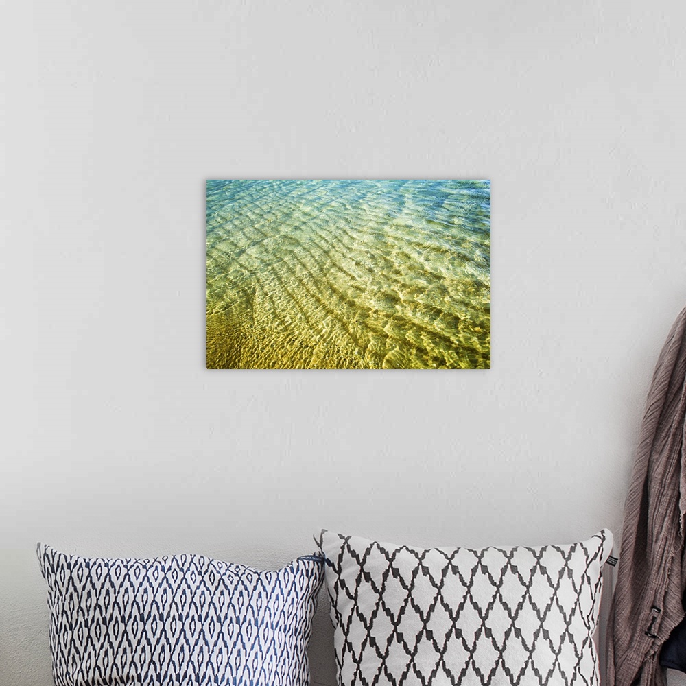 A bohemian room featuring A photograph of green and blue water of Hawaiian beaches.