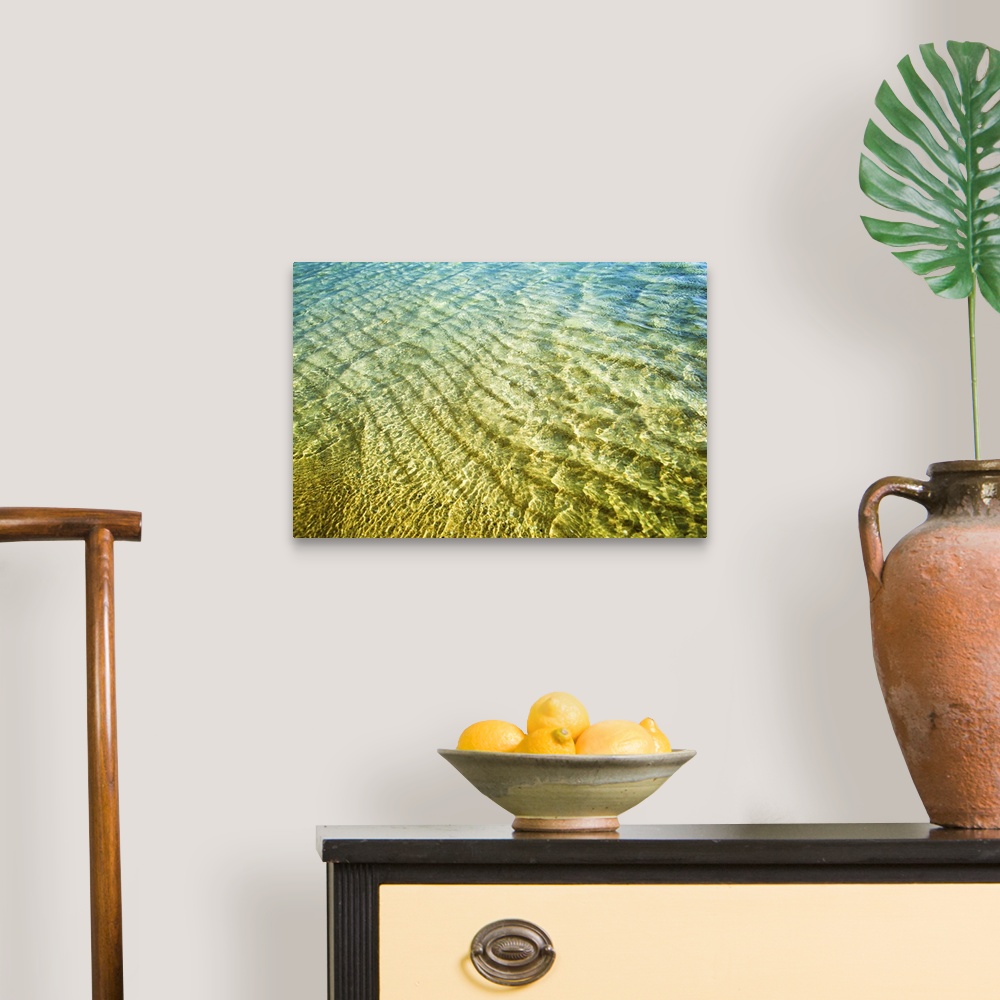 A traditional room featuring A photograph of green and blue water of Hawaiian beaches.