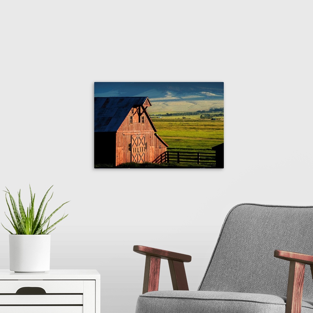 A modern room featuring Photograph of a red barn with green farmland in the background.