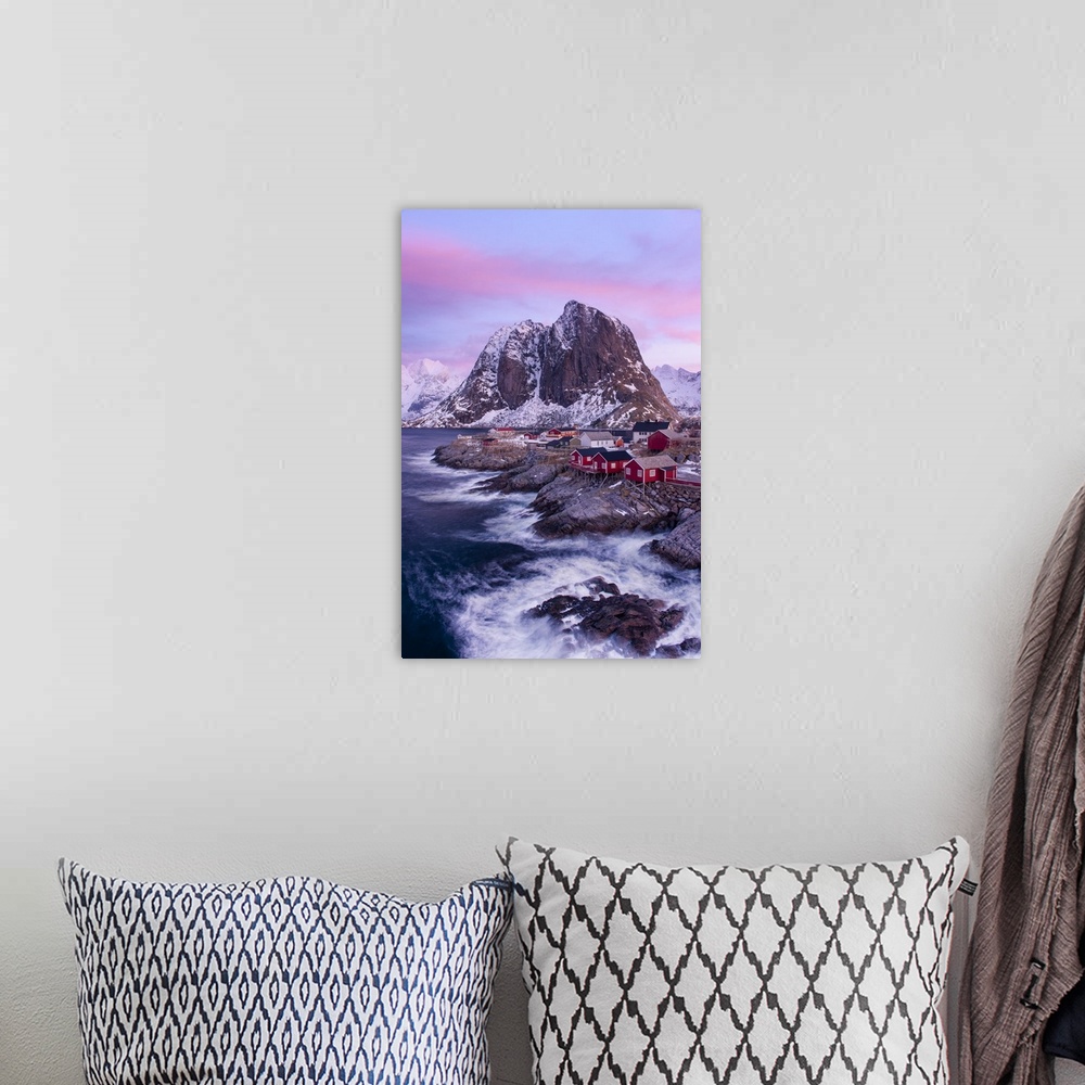 A bohemian room featuring A photograph of a snow covered mountainscape under a pink and purple sky.